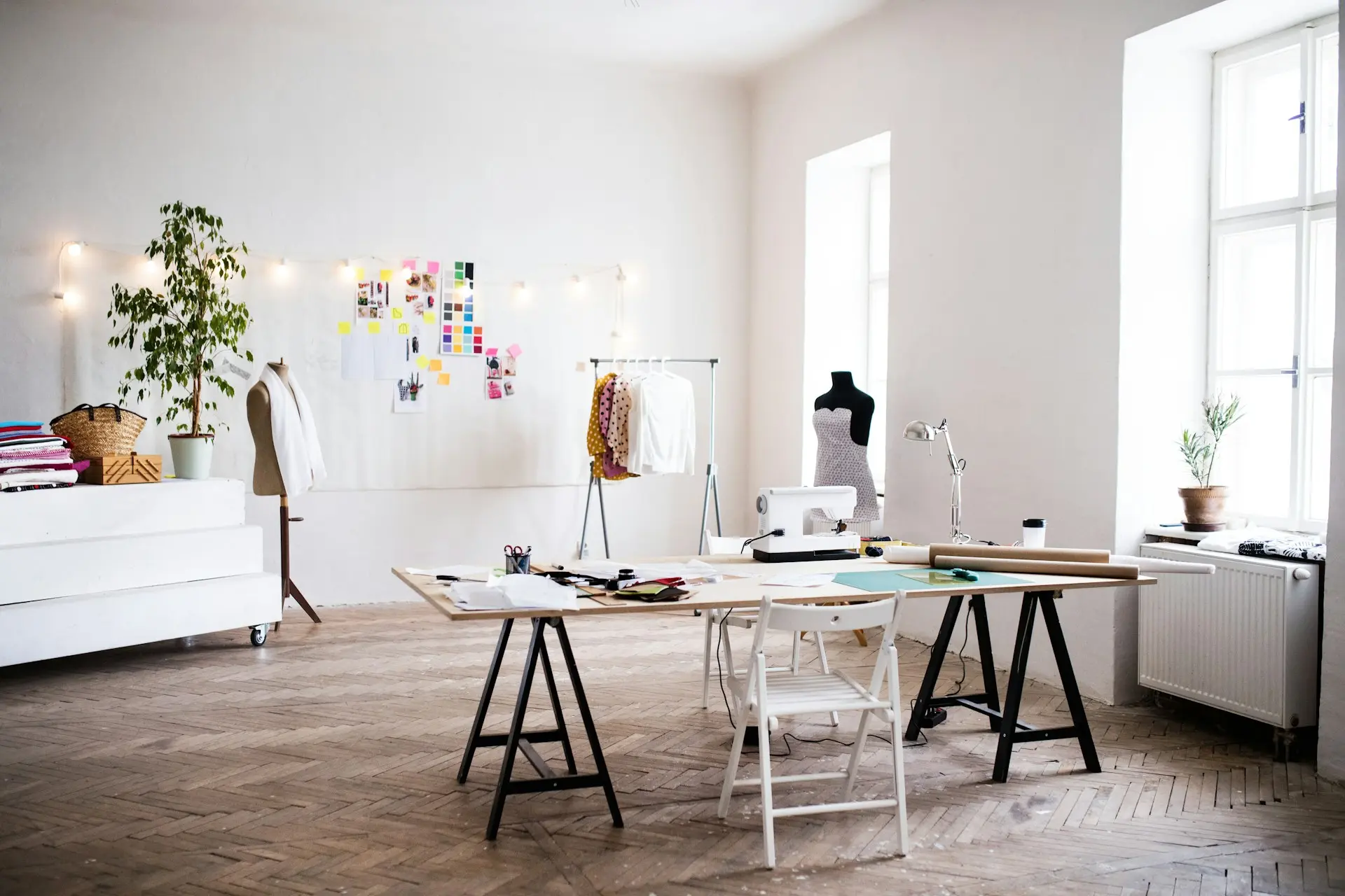 a well-lit room with a sewing machine and work table